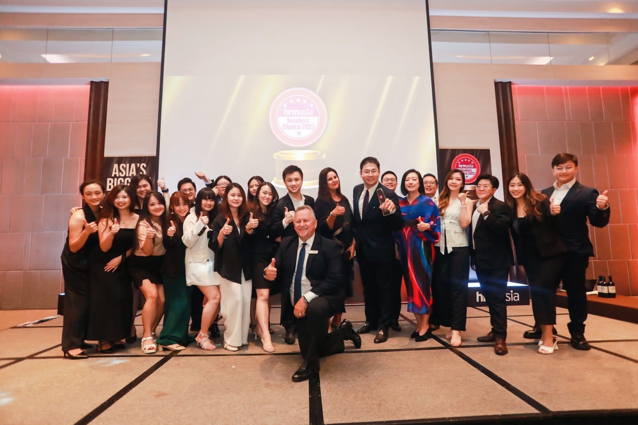 The MCI team on stage with the Gold trophy at the HRM Asia Readers' Choice Awards 2023