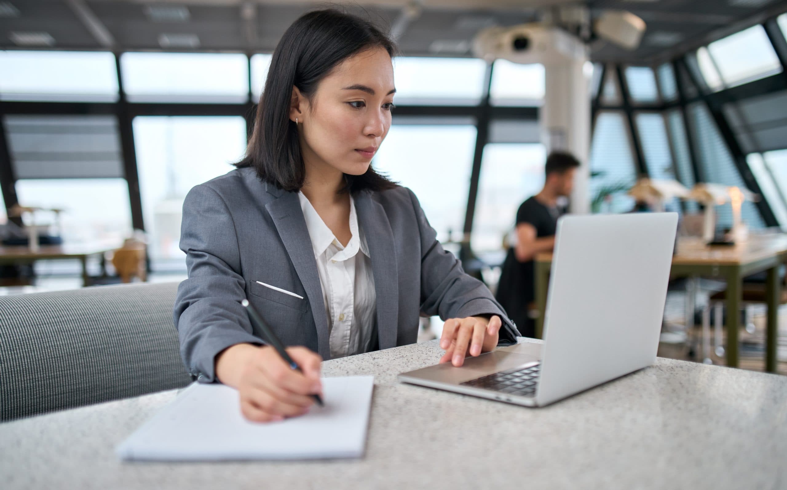 An MCI recruitment consultant working through a shortlist on a laptop