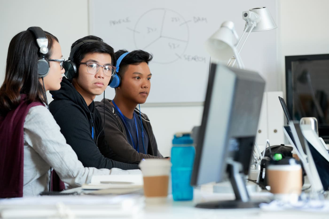 A team of developers at work along a row of desks