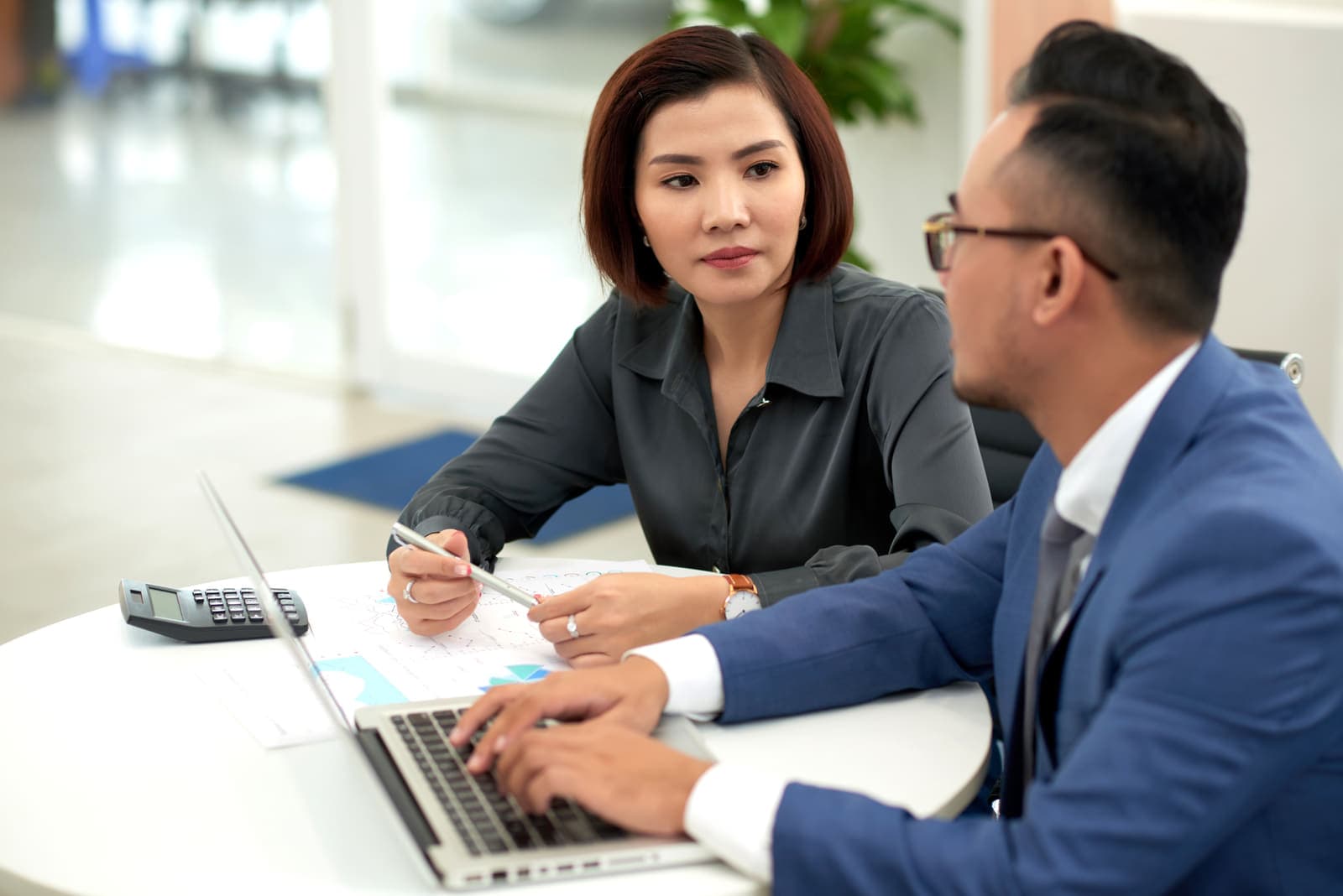 An adviser going through figures with a client across a meeting table